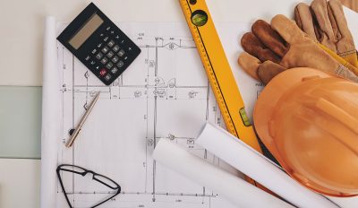 Blueprint, level and belongings of construction engineer